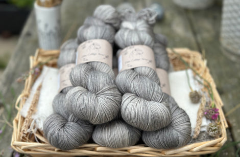 Five skeins of semi-solid medium toned grey yarn