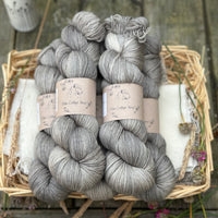 Five skeins of semi-solid medium toned grey yarn