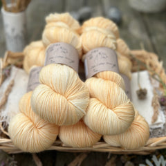 Five skeins of hand dyed yarn in a semi-solid honey colour. 