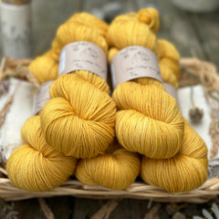 Five skeins of golden yellow yarn. 