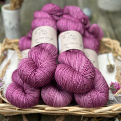 Five skeins of purplish pink yarn. 