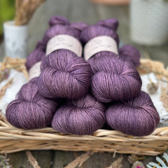 Five skeins of darkish purple yarn. 