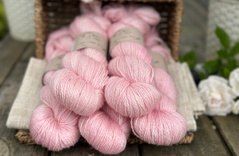 five skeins of hand dyed yarn in a soft pink colour