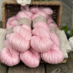 five skeins of hand dyed yarn in a soft pink colour