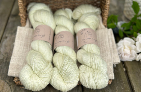 five skeins of hand dyed yarn in a very light spring green colour