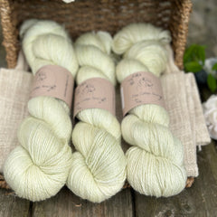 five skeins of hand dyed yarn in a very light spring green colour