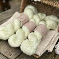 five skeins of hand dyed yarn in a very light spring green colour