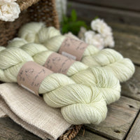 five skeins of hand dyed yarn in a very light spring green colour