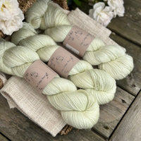 five skeins of hand dyed yarn in a very light spring green colour