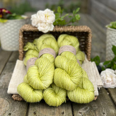 five skeins of hand dyed yarn in a soft but zingy green colour