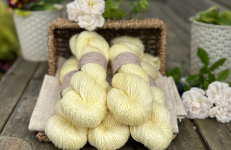 five skeins of hand dyed yarn in a light greenish yellow colour