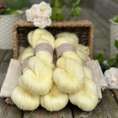 five skeins of hand dyed yarn in a light greenish yellow colour