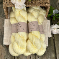 five skeins of hand dyed yarn in a light greenish yellow colour