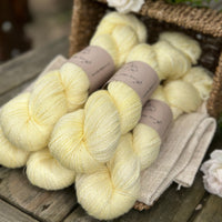 five skeins of hand dyed yarn in a light greenish yellow colour