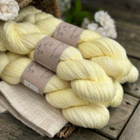 five skeins of hand dyed yarn in a light greenish yellow colour