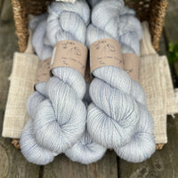 five skeins of hand dyed yarn in a light ice blue colour