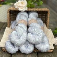 five skeins of hand dyed yarn in a light ice blue colour