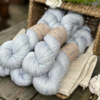 five skeins of hand dyed yarn in a light ice blue colour