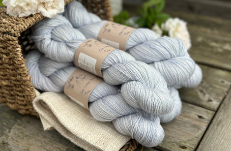 five skeins of hand dyed yarn in a light ice blue colour