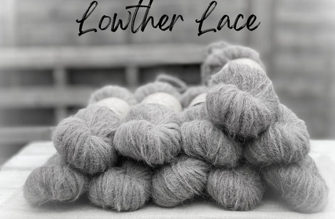 A black and white image of fluffy laceweight yarn. Lowther Lace is written in black text across the top of the image