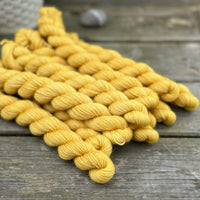 Rich yellow mini skeins of yarn