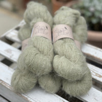 Five skeins of fluffy green yarn