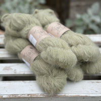 Five skeins of fluffy green yarn