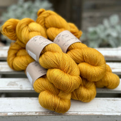 Five skeins of rich yellow yarn