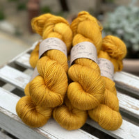 Five skeins of rich yellow yarn