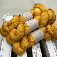 Five skeins of rich yellow yarn