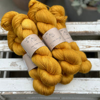 Five skeins of rich yellow yarn