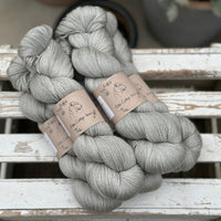 Five skeins of grey yarn