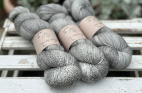 Three skeins of grey yarn