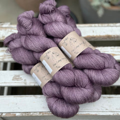 Five skeins of purple yarn