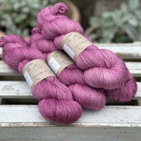 Four skeins of light purpley-pink yarn