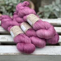 Four skeins of light purpley-pink yarn