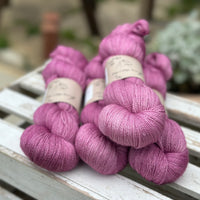 Four skeins of light purpley-pink yarn