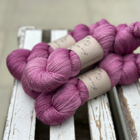 Four skeins of light purpley-pink yarn