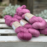 Four skeins of light purpley-pink yarn