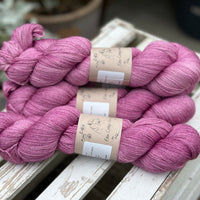 Four skeins of light purpley-pink yarn