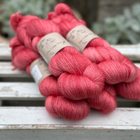 Five skeins of bright pink yarn