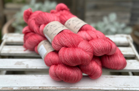 Five skeins of bright pink yarn