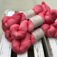 Five skeins of bright pink yarn