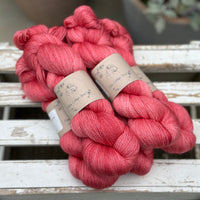 Five skeins of bright pink yarn