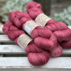Five skeins of purpley-red yarn