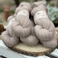 Five skeins of light brown yarn