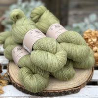 Five skeins of green laceweight yarn