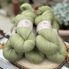 Five skeins of green laceweight yarn