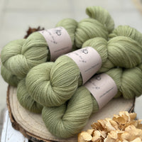 Five skeins of green laceweight yarn