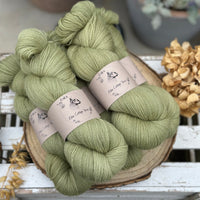 Five skeins of green laceweight yarn